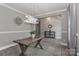 Bright dining room with wood table, stylish lighting and gray walls at 3709 Creek Ridge Dr, Denver, NC 28037