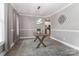 Bright dining room with a rustic table, modern lighting, and a view into the updated kitchen at 3709 Creek Ridge Dr, Denver, NC 28037