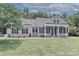 Traditional home featuring gray siding, dark shutters, brick accents, and a lush front lawn at 3709 Creek Ridge Dr, Denver, NC 28037
