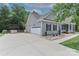 Charming home featuring a side-entry garage, stone accents, and well-manicured landscaping at 3709 Creek Ridge Dr, Denver, NC 28037