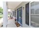 Close-up of a blue front door with black shutters, a welcoming mat, and a decorative flower pot at 3709 Creek Ridge Dr, Denver, NC 28037