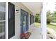 Charming porch featuring a blue door, black shutters, and decorative accents, perfect for a warm welcome at 3709 Creek Ridge Dr, Denver, NC 28037