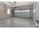 Well-lit garage featuring epoxy flooring, overhead storage, and ample space at 3709 Creek Ridge Dr, Denver, NC 28037
