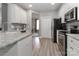 Bright kitchen boasts stainless appliances, granite counters, white cabinets and an open floorplan at 3709 Creek Ridge Dr, Denver, NC 28037