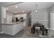 Open kitchen and dining area with modern appliances, white cabinets, and granite countertop at 3709 Creek Ridge Dr, Denver, NC 28037