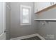 Bright laundry room with white cabinets, shelving, and a window at 3709 Creek Ridge Dr, Denver, NC 28037