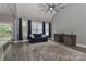 Bright living room with modern ceiling fan, large windows, and comfortable seating at 3709 Creek Ridge Dr, Denver, NC 28037