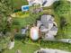 Aerial view of a house with an in-ground pool, landscaping, and a well-maintained lawn at 389 Ponderosa Cir, Mooresville, NC 28117