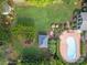 An aerial view shows a backyard with a swimming pool, green grass, a gazebo, and landscaping at 389 Ponderosa Cir, Mooresville, NC 28117