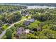 Aerial view shows homes with green lawns and a lake in the background at 389 Ponderosa Cir, Mooresville, NC 28117