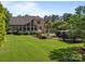 Brick home backyard with sunroom addition and fenced pool surrounded by mature landscaping at 389 Ponderosa Cir, Mooresville, NC 28117