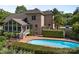 Spacious backyard with fenced pool, brick home with sunroom addition, and beautiful landscaping at 389 Ponderosa Cir, Mooresville, NC 28117