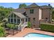 Spacious backyard with fenced pool, brick home with sunroom addition, and beautiful landscaping at 389 Ponderosa Cir, Mooresville, NC 28117