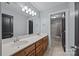Bathroom with double sink vanity, large mirror, and tile flooring at 389 Ponderosa Cir, Mooresville, NC 28117