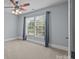 Bedroom with carpet, ceiling fan, and a window with curtains at 389 Ponderosa Cir, Mooresville, NC 28117