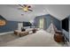 Spacious bonus room boasts neutral carpet, fan, blue accent wall, and a cute teepee tent at 389 Ponderosa Cir, Mooresville, NC 28117