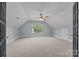 Spacious bonus room with a ceiling fan and natural light from a large window at 389 Ponderosa Cir, Mooresville, NC 28117