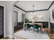 Dining room with wainscoting, decorative mirror, chandelier, and windows offering plenty of natural light at 389 Ponderosa Cir, Mooresville, NC 28117