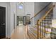 Bright foyer featuring hardwood floors, stairs, and a view of the front entrance through arched doorway at 389 Ponderosa Cir, Mooresville, NC 28117