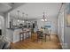 Open kitchen and breakfast area with light cabinets, bar seating and stainless appliances at 389 Ponderosa Cir, Mooresville, NC 28117