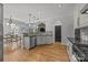 Open kitchen with modern appliances, black countertops, and decorative backsplash at 389 Ponderosa Cir, Mooresville, NC 28117