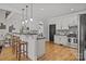 Beautiful kitchen boasts hardwood floors, white cabinets, a breakfast bar, and modern appliances at 389 Ponderosa Cir, Mooresville, NC 28117