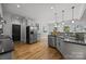 Bright kitchen features modern stainless steel appliances, a stylish backsplash and hardwood floors at 389 Ponderosa Cir, Mooresville, NC 28117