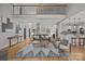 Open concept living room with hardwood floors, view of second floor, and dining area with kitchen at 389 Ponderosa Cir, Mooresville, NC 28117