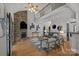 Open living room features a stone fireplace, wood floors, a vaulted ceiling and a view to the second floor at 389 Ponderosa Cir, Mooresville, NC 28117