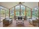 Bright sunroom with large windows and cozy wicker furniture at 389 Ponderosa Cir, Mooresville, NC 28117