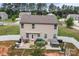 Aerial view of the home showing a large patio with grill and furniture set at 413 Wheat Field Dr, Mount Holly, NC 28120