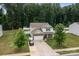 Aerial view of a two-story home with a fenced backyard and a lush, green lawn at 413 Wheat Field Dr, Mount Holly, NC 28120