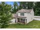 Aerial view of a two-story home with a well-maintained lawn and a wooded backdrop at 413 Wheat Field Dr, Mount Holly, NC 28120