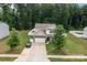 Aerial view of a two-story home with a fenced backyard and a long driveway at 413 Wheat Field Dr, Mount Holly, NC 28120