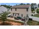 Back of the house with a patio including furniture, grill, hot tub, and a small yard at 413 Wheat Field Dr, Mount Holly, NC 28120