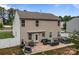 View of the back of the house with a patio including furniture, a grill, and a hot tub at 413 Wheat Field Dr, Mount Holly, NC 28120