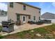 Back of the house with a patio including furniture, a grill, and a hot tub at 413 Wheat Field Dr, Mount Holly, NC 28120