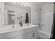 Bright bathroom featuring a double sink vanity, large mirror, and shower-tub combo at 413 Wheat Field Dr, Mount Holly, NC 28120