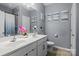 Bathroom featuring double sinks, modern fixtures, tile floors, and neutral paint at 413 Wheat Field Dr, Mount Holly, NC 28120