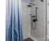 Close-up of bathroom shower featuring modern fixtures, tile surround, and glass door at 413 Wheat Field Dr, Mount Holly, NC 28120