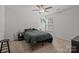 Carpeted bedroom with a ceiling fan and natural light from the window at 413 Wheat Field Dr, Mount Holly, NC 28120