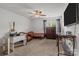 Bedroom features a ceiling fan, carpeted floor, and large window, with desk and futon at 413 Wheat Field Dr, Mount Holly, NC 28120