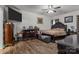 Bedroom features hardwood floors, a large bed, and dresser, with neutral decor at 413 Wheat Field Dr, Mount Holly, NC 28120