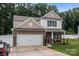 Beautiful two-story home with a two-car garage, stone accents, and a well-maintained lawn at 413 Wheat Field Dr, Mount Holly, NC 28120