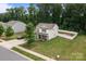 Charming two-story home with manicured lawn, long driveway, and partial privacy fence at 413 Wheat Field Dr, Mount Holly, NC 28120