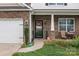 Inviting covered front porch with decorative stone pillars and a cozy seating area at 413 Wheat Field Dr, Mount Holly, NC 28120