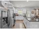 Modern kitchen with white cabinets and stainless steel appliances and large island at 413 Wheat Field Dr, Mount Holly, NC 28120