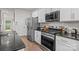 Modern kitchen featuring stainless steel appliances, granite countertops, and hardwood flooring at 413 Wheat Field Dr, Mount Holly, NC 28120