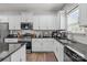 Modern kitchen with white cabinets, stainless appliances, and granite countertops at 413 Wheat Field Dr, Mount Holly, NC 28120