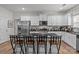 Modern kitchen with granite countertops and white cabinets offers a breakfast bar at 413 Wheat Field Dr, Mount Holly, NC 28120